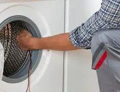 Dryer repair technician diagnosing and servicing a clothes dryer in Des Moines, IA