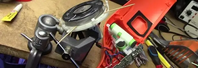 Vacuum cleaner repair parts and tools on a workbench in Des Moines, IA