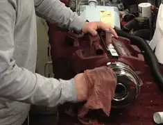 Vacuum repair technician cleaning and servicing a vacuum motor in Des Moines, IA